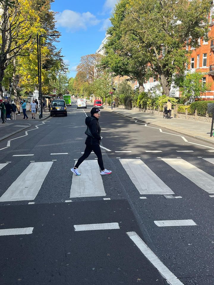 Courtney Caruso walks across Abbey Road