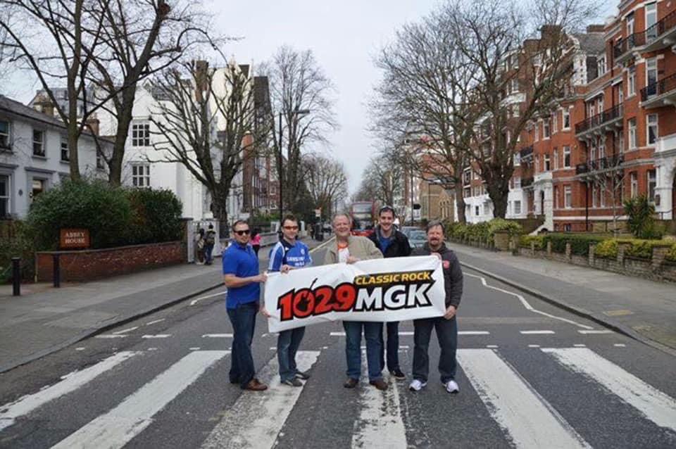 Ted Siuta holds up an MGK banner at Abbey Road