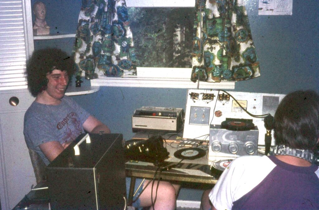 Andre Gardner and friend at the controls of his pirate radio station