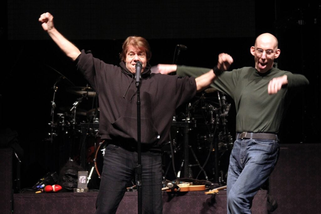 George Thorogood pushes Andre Gardner off stage.