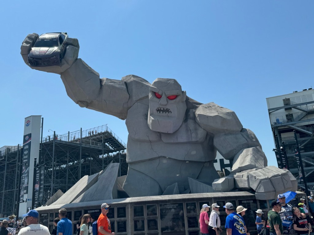 Miles the Monster, Dover Motor Speedway's mascot greets fans entering to see a Nascar race.