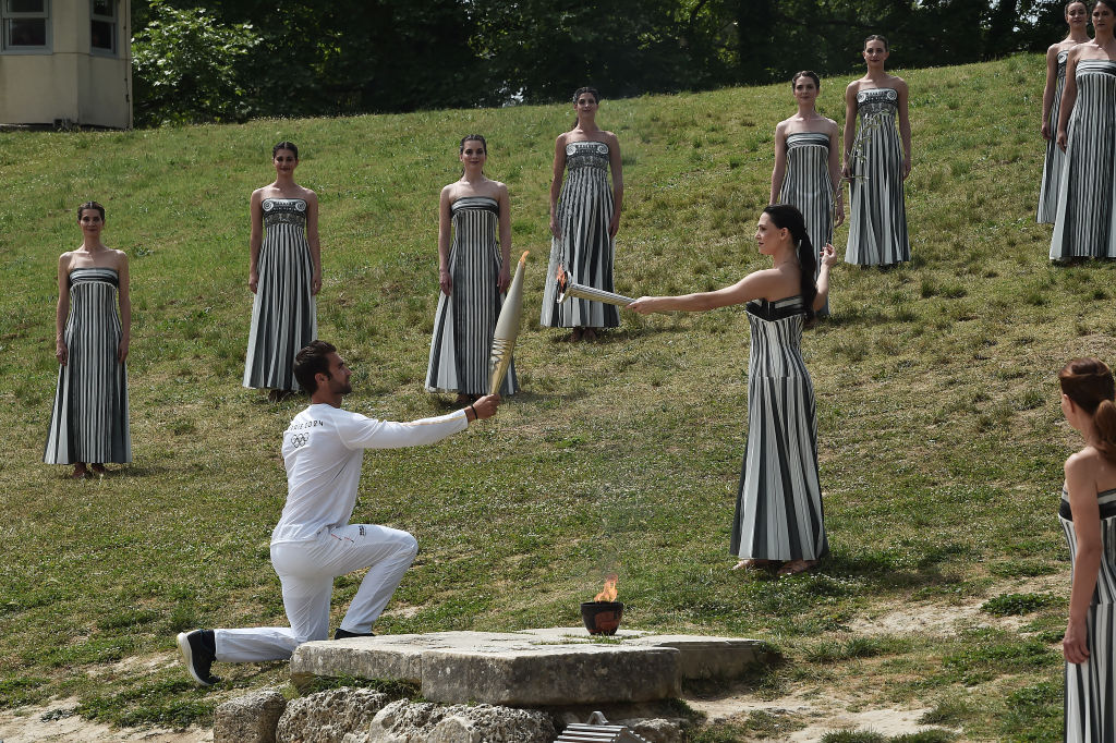 The Olympic Torch being lit in ancient Olympia, Greece.