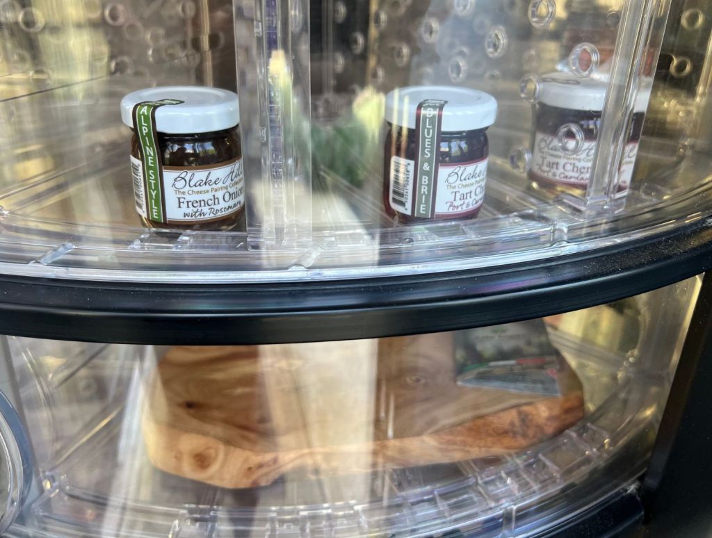 Jams and chutneys and even a cheese board inside the glass of the cheese vending machine.