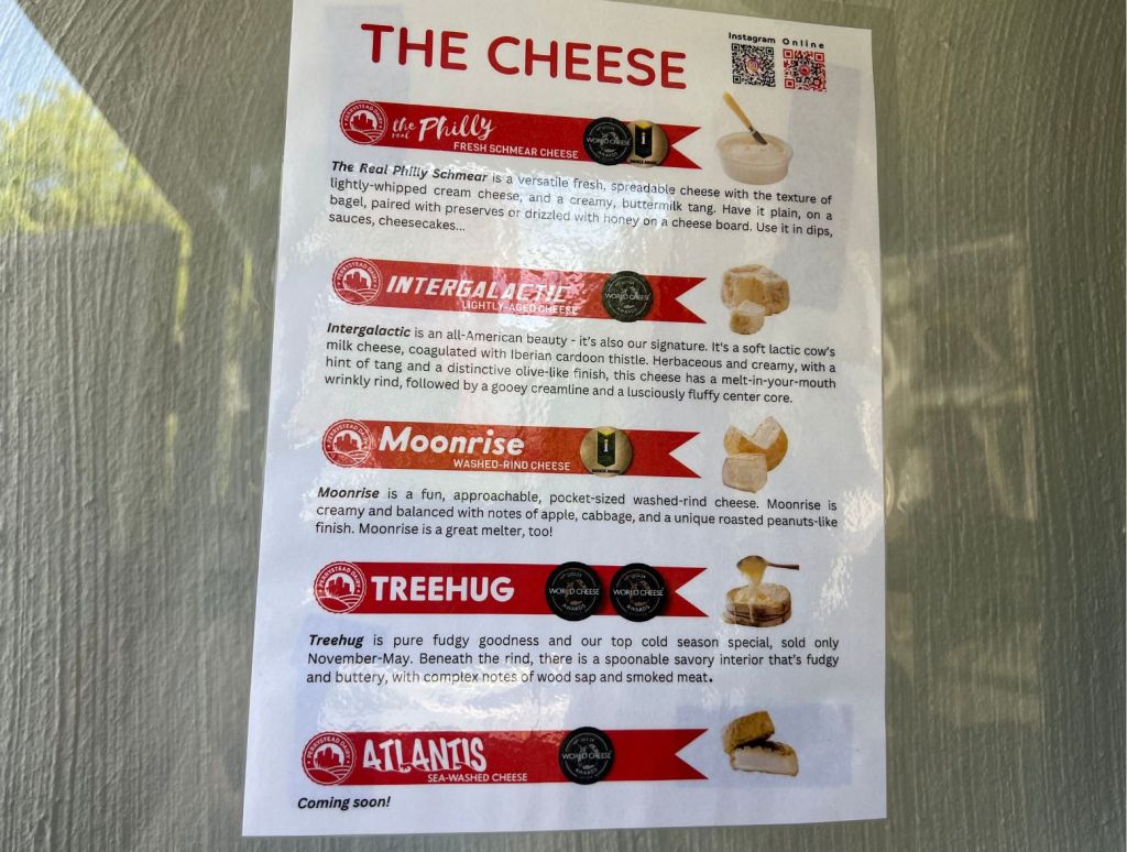 A menu of the current deliciousc heese options is posted on the left wall adjacent to the cheese vending machine.