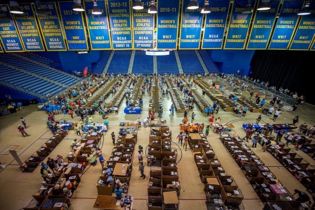 Photo shows an auditorium with rows upon rows of crates filled with adoptable animals. Over 1,000 adoptable pets available at the Brandywine Valley SPCA's Mega Adoption Event 2024.