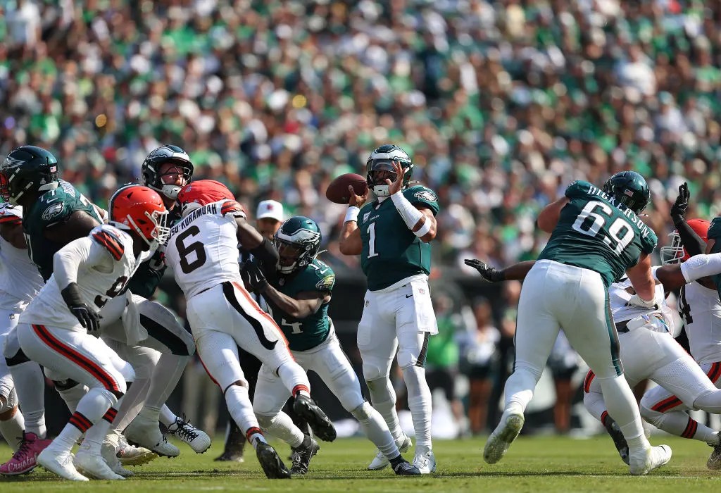 PHILADELPHIA, PENNSYLVANIA - OCTOBER 13: Jalen Hurts #1 of the Philadelphia Eagles throws a touchdown pass to A.J. Brown #11 during the second quarter against the Cleveland Browns at Lincoln Financial Field on October 13, 2024 in Philadelphia, Pennsylvania. 